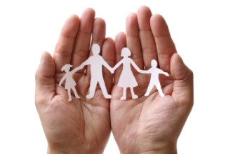 Image of hand holding a paper chian family